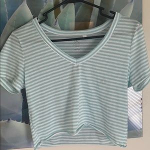 Two crop topped PAC SUN shirts.